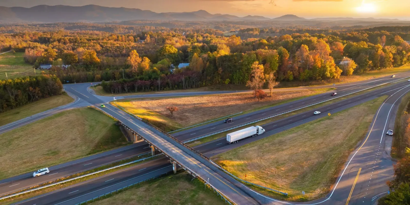 less-than-truckload-truck-freeway-overpass Aerial view of a freeway overpass. A truck carrying a LTL shipment is driving under the overpass.
