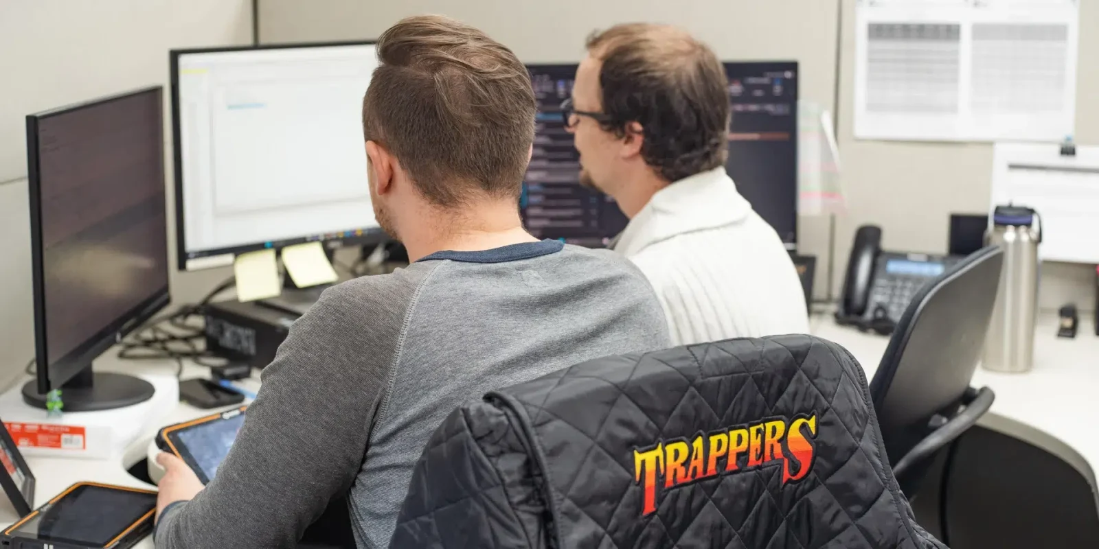 A pair of Trappers Transport employees at their Winnipeg, Manitoba facility, planning logistics for a container shipment.